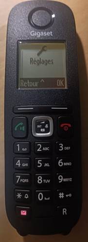 A black cordless phone

Description automatically generated