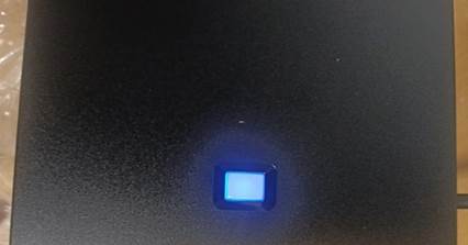 A blue light on a black surface

Description automatically generated